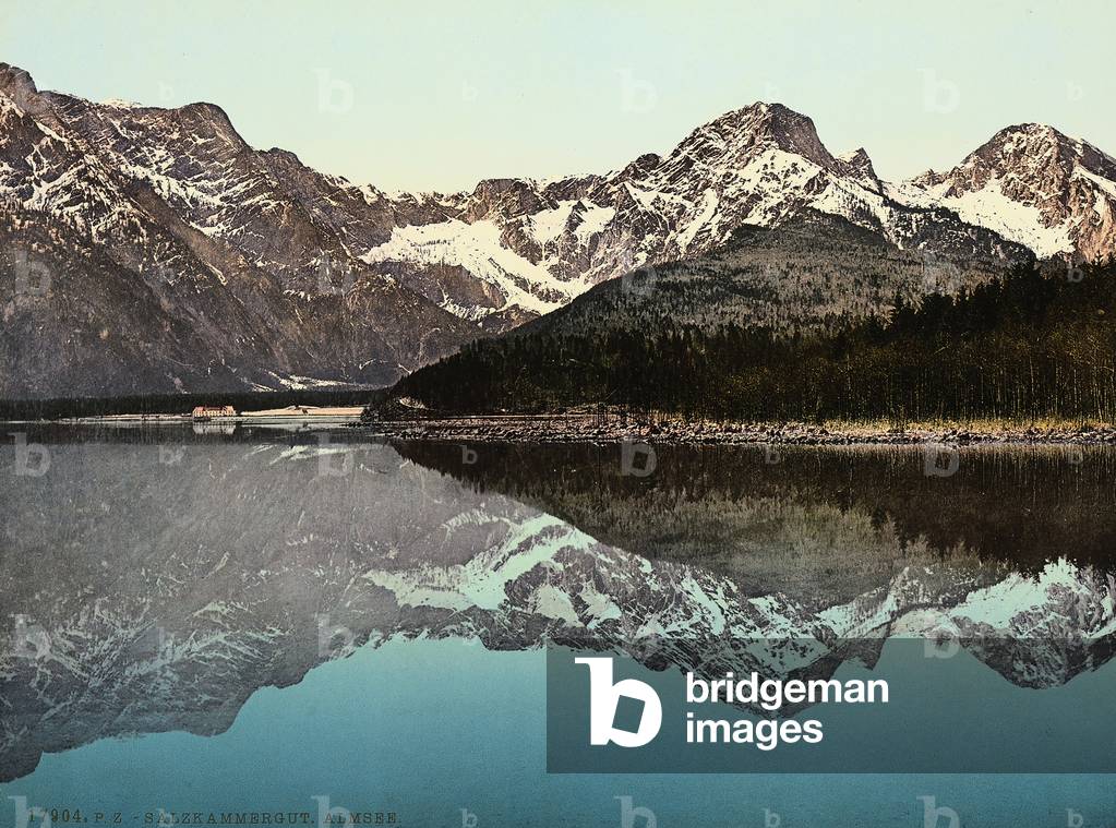 Mountains of the region of Salzkammergut, reflected in the water of lake Almsee, Austria.