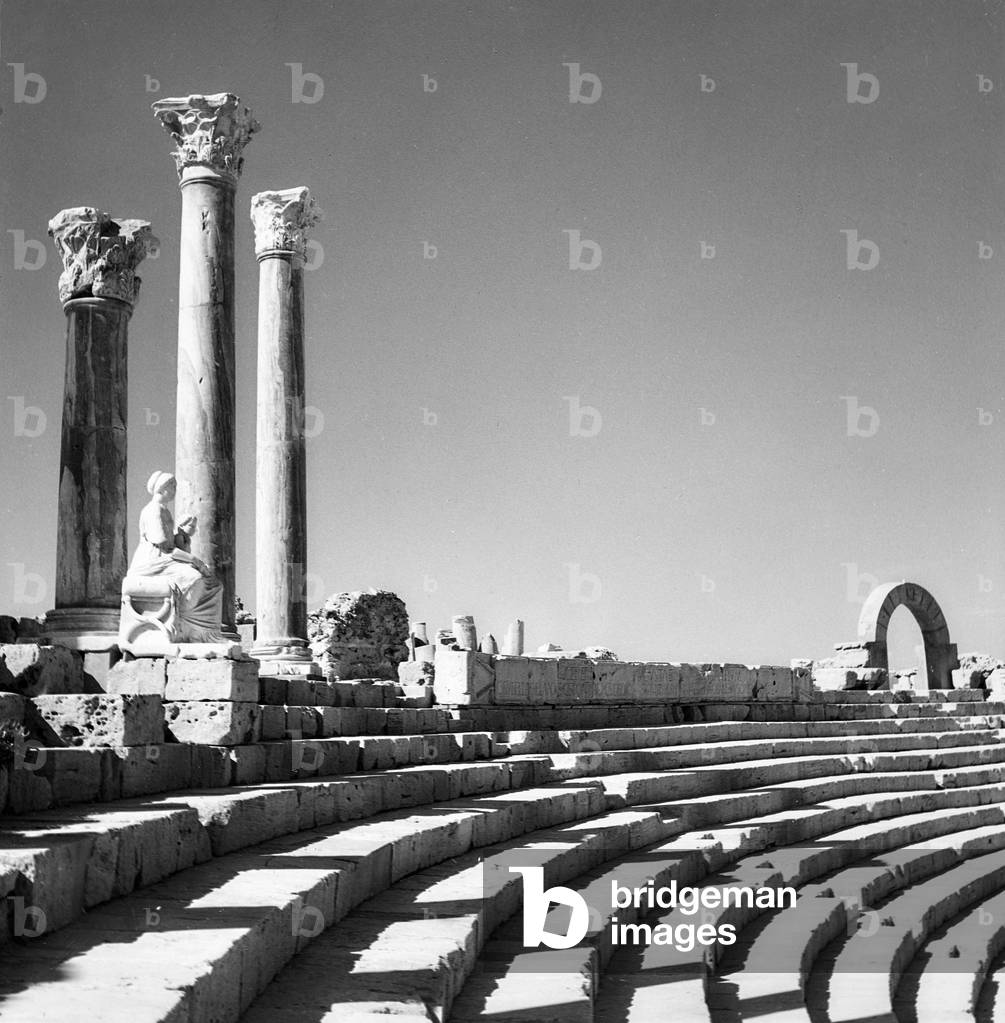Female statue, columns and tiers of the Roman theater, Leptis Magna