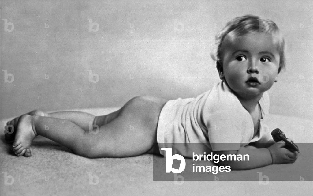 Portrait of a half nude infant lying on its stomach