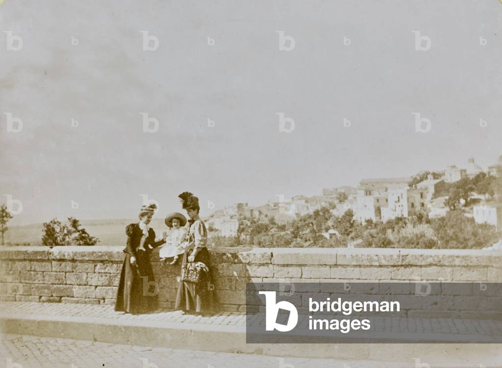 Portrait of two women with a child and in the background Ariccia