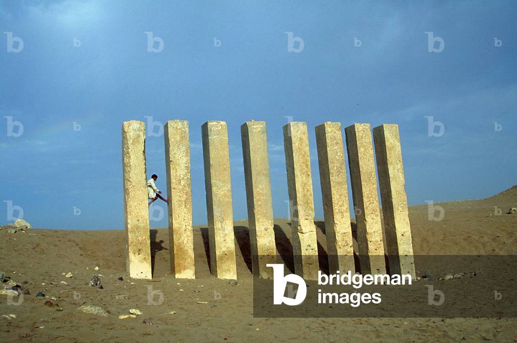 A boy amongst the pillars of the temple of Bilqis in Ma'rib, in the province of Ma'rib Mahram Bilqis, Yemen (photo)