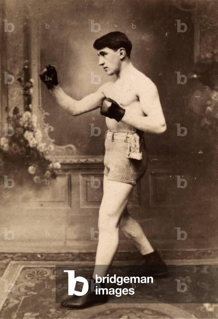Studio portrait of a boxer in an action pose.
