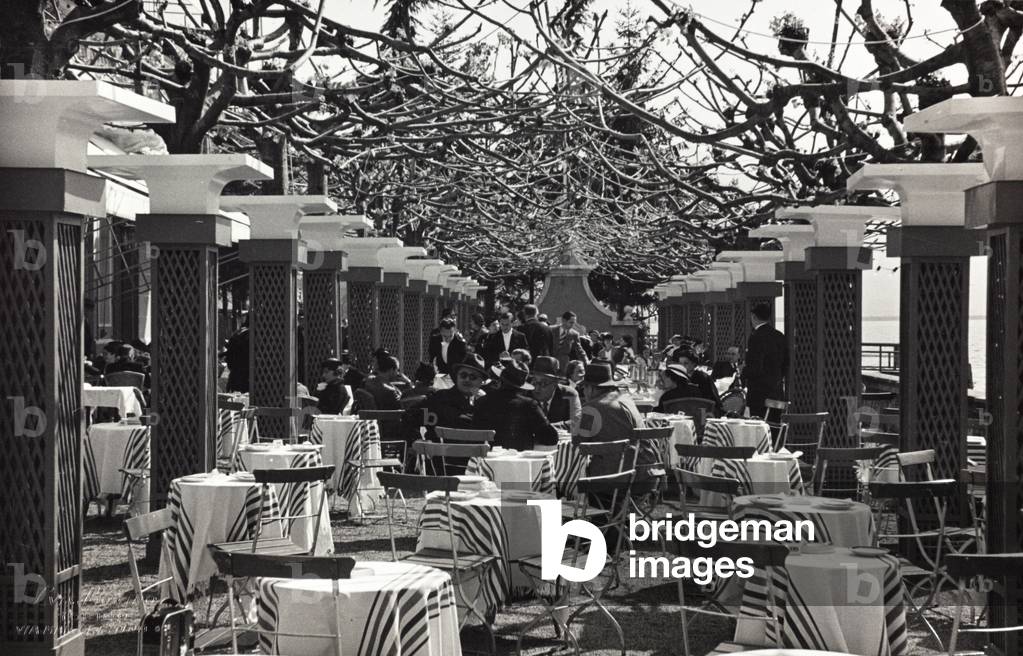 Group of people sitting at the café during a fashion event