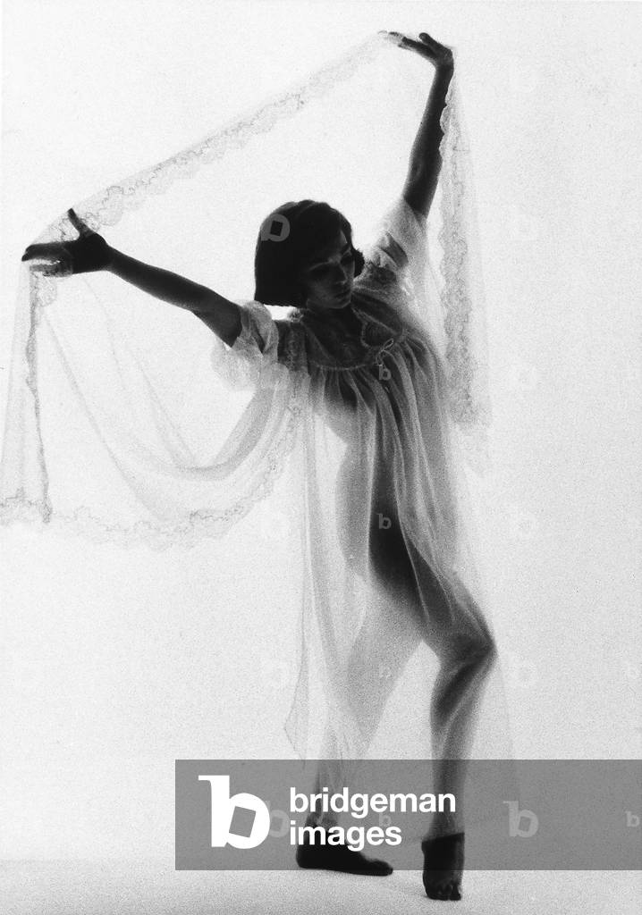A model wearing a nightshirt and an embroidered transparent sheet.