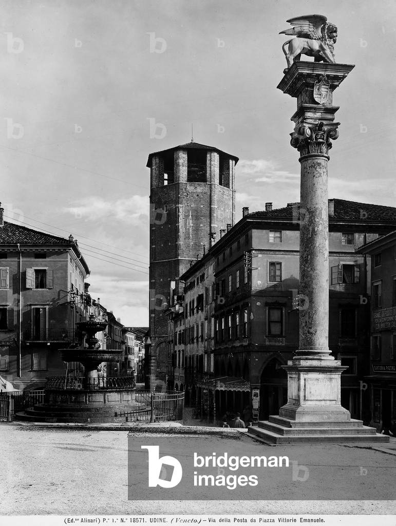 View of Via della Posta from Piazza della Libertà, formerly Piazza Vittorio Emanuele, in Udine. In the foreground, the marble column topped by St. Mark's Lion