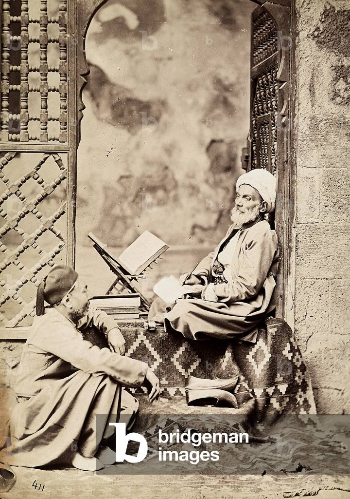 An Egyptian theologian writes while seated in a doorway, 1880 (print on double-weight paper)