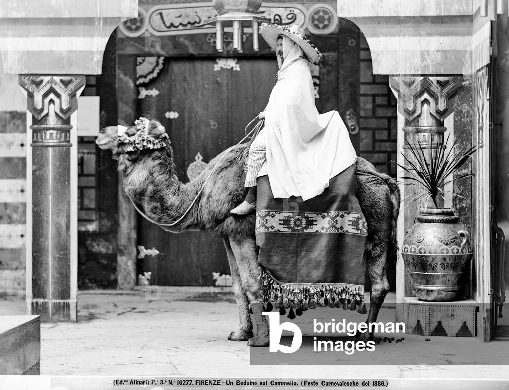 A man dressed as a Bedouin on the back of a camel, during the Carnival festivities held in Florence in 1886
