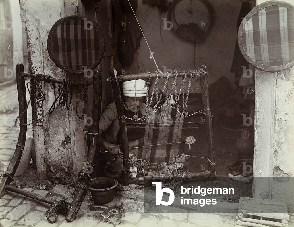 A Turkish artisan, sitting on the ground, weaving on a loom, 1890 (print on double-weight paper)