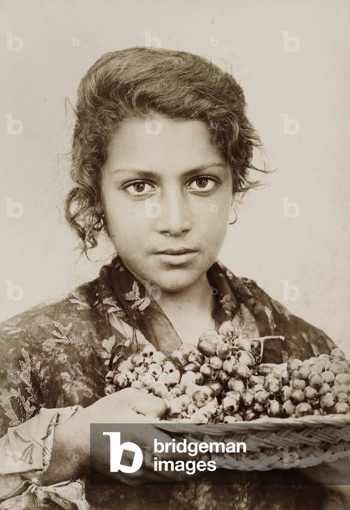 Sicilian girl with a bunch of grapes
