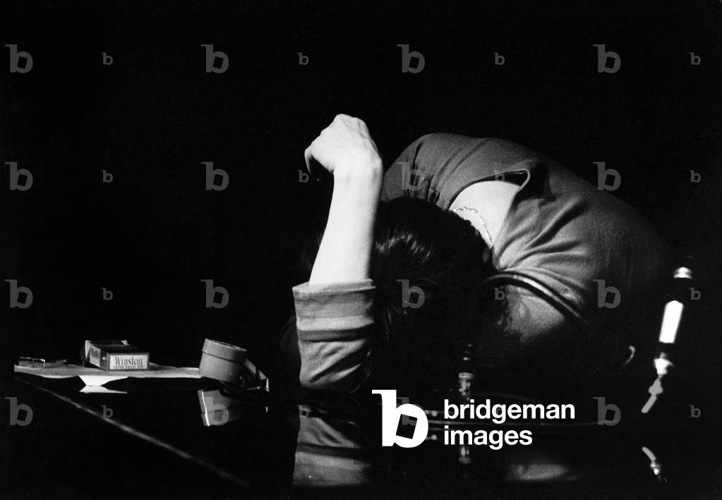 Woman slumped over a table