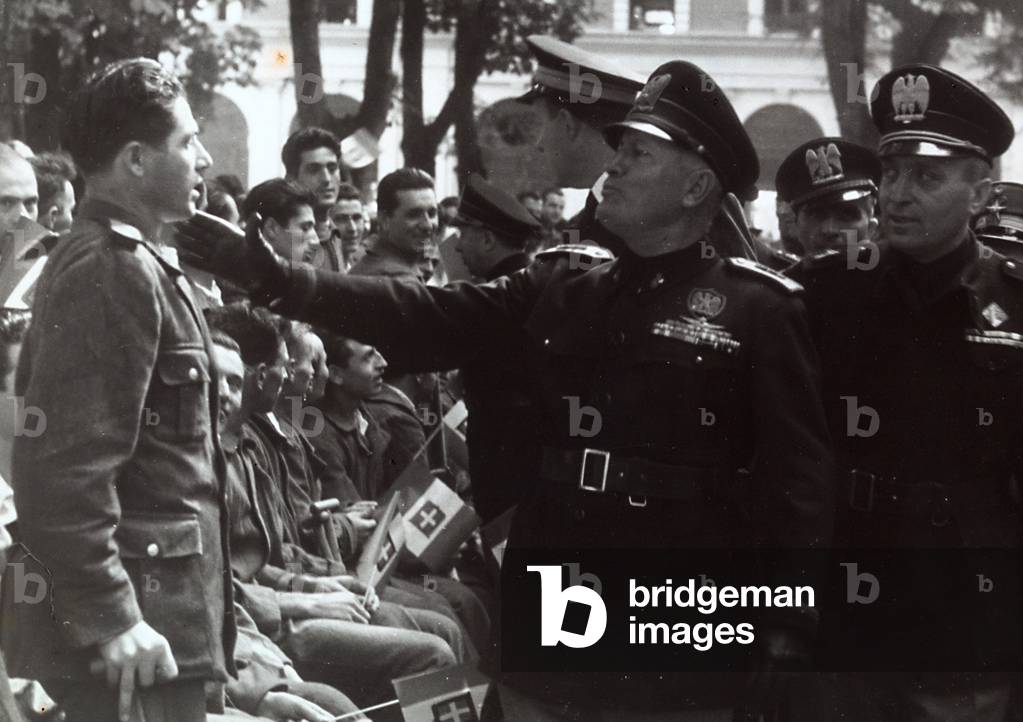 Mussolini saluting a soldier (b/w photo)