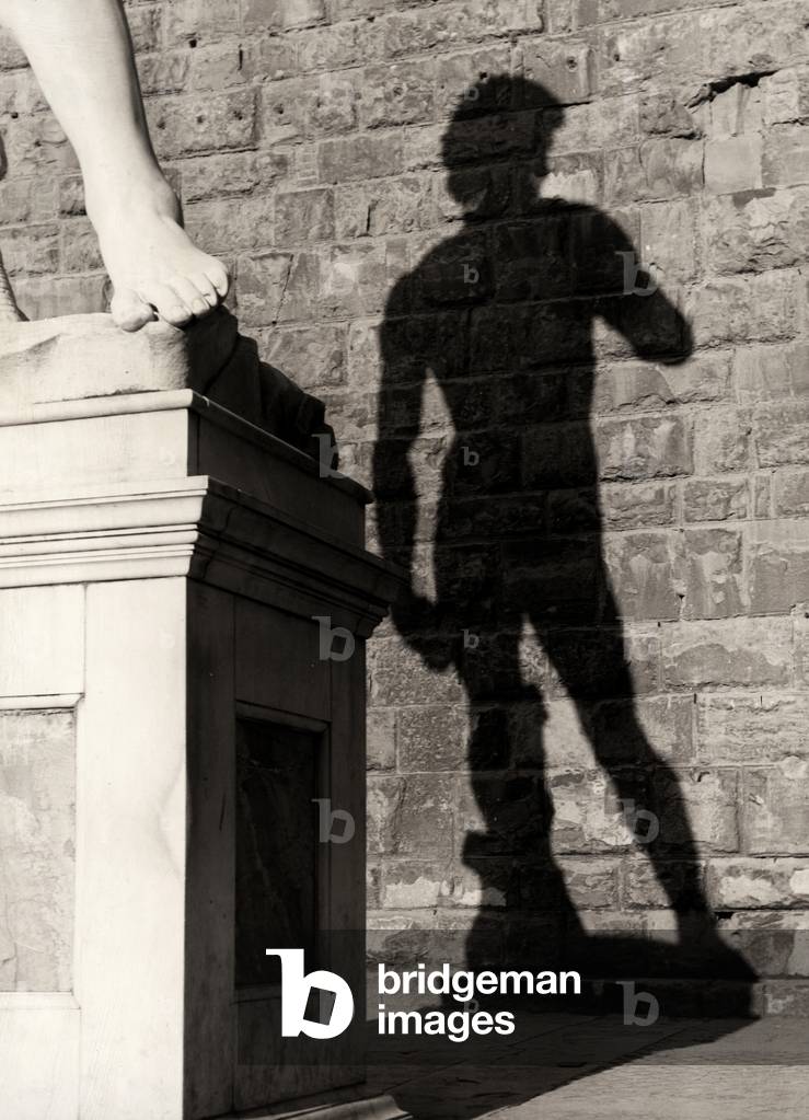 Shadow of the copy of the statue of David, Piazza della Signoria, Florence, Italy (b/w photo)