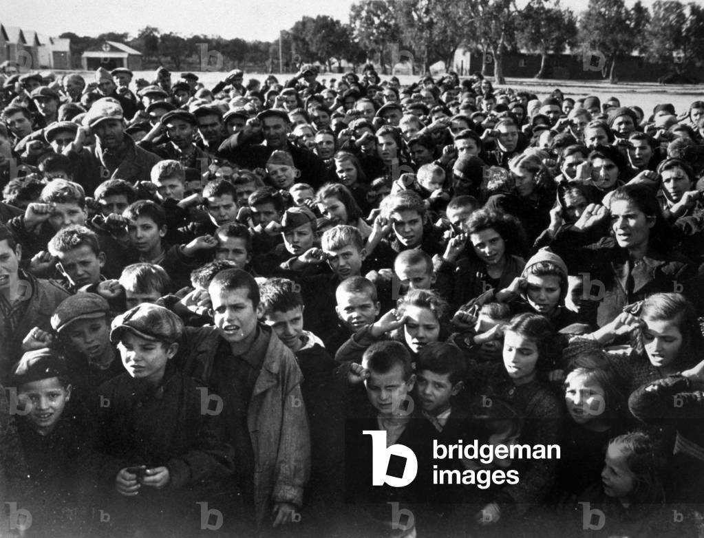 A group of refugees from Yugoslavia given shelter in an Italian camp at the end of World War II (b/w photo)