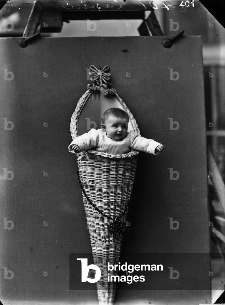 Portrait of a new-born baby in a pannier