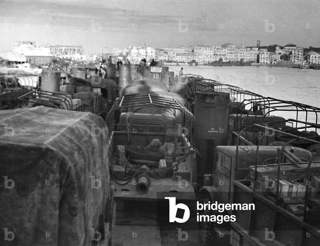 Jeeps being transported on a Navy ship in the Port of Anzio (b/w photo)