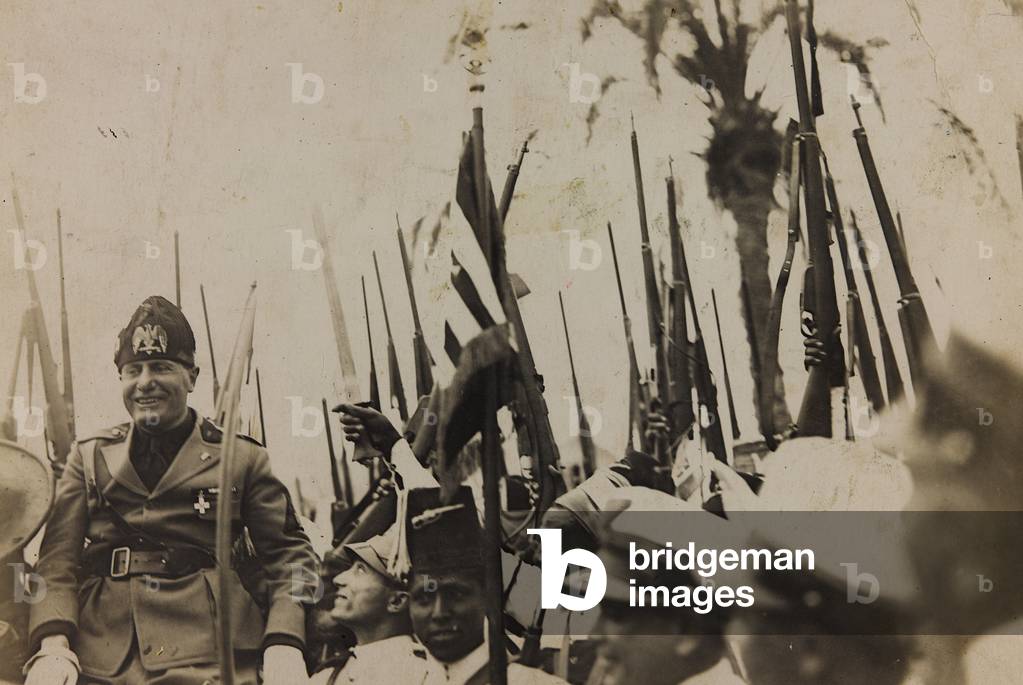 Benito Mussolini carried in triumph by the colonial troops (b/w photo)