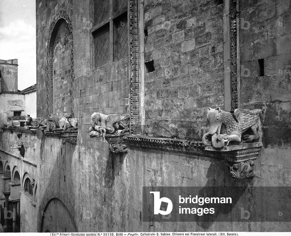 Statues of chimeras located right outside the side windows of the cathedral of San Sabino in Bari, Puglia