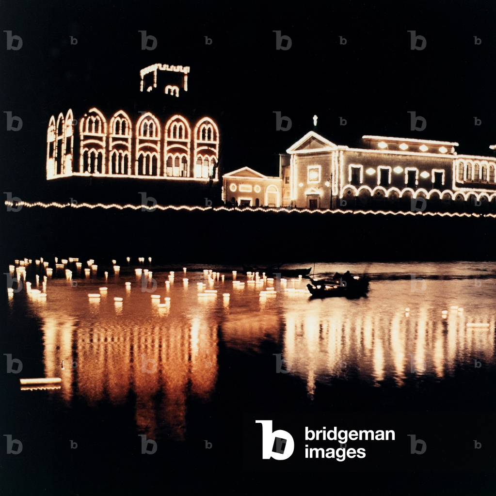 Illuminated buildings along the seaside of Pisa