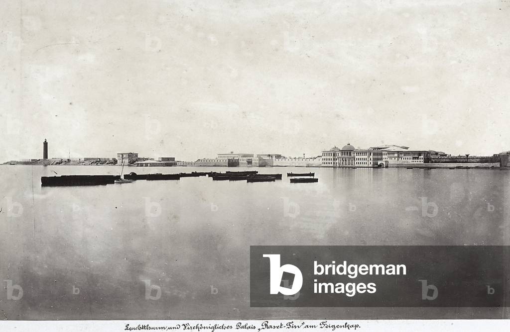 Boats in the middle of the sea with part of the city of Alexandria in the background, in Egypt