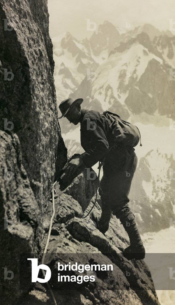 A hiker climbing a mountain in Switzerland