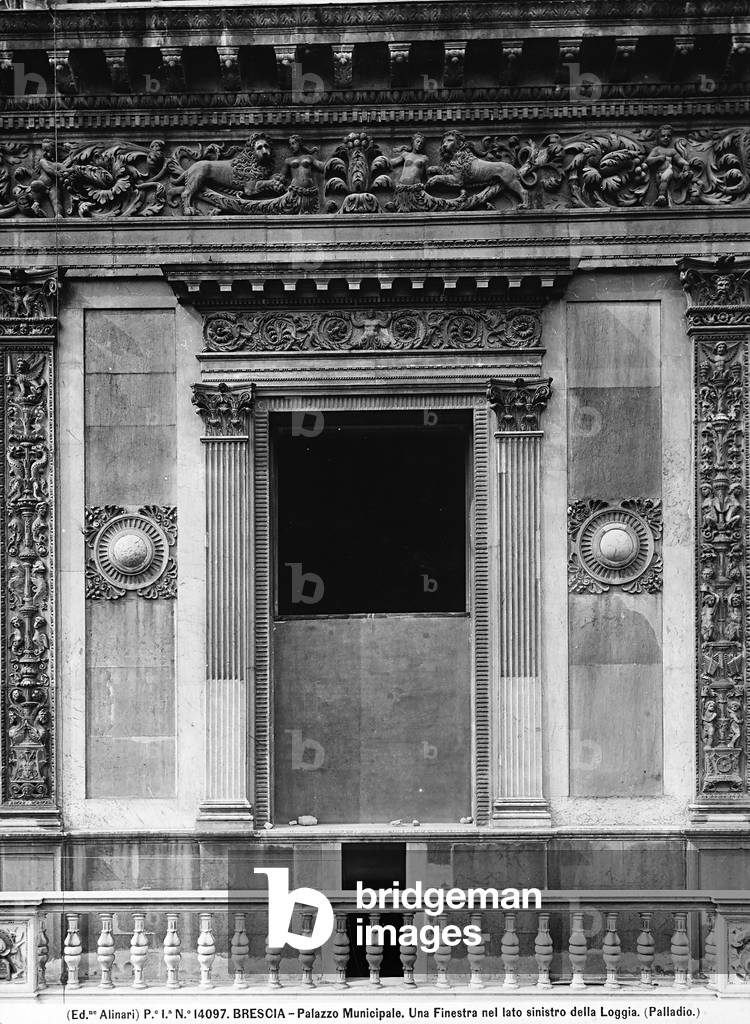 A window on the left side of the Palazzo del Comune or Piazza della Loggia, in Piazza della Loggia in Brescia. The window was executed on a design by Ludovico Beretta