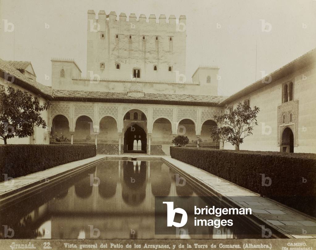 The 'Patio de los Arrayanes' (Court of the Myrtles) and the 'Torre de Comares' in the Palace of the Alhambra (the Red Castle) in Granada. The courtyard with the elegant porticoes on the short sides has a rectangular fishpond at the center with hedges of myrtle