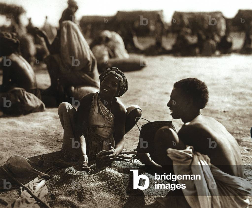 Young pair of Ethiopians collecting seeds, 1935 (print on double-weight paper)