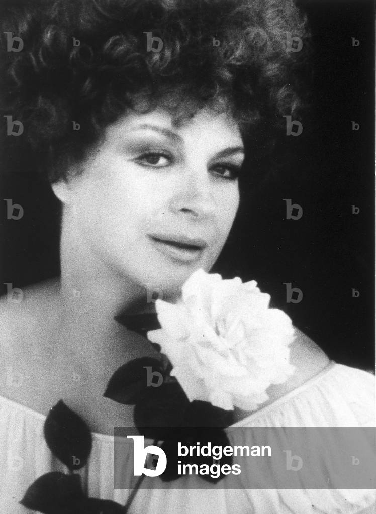 Portrait of singer Katina Ranieri with a white rose in her hand.