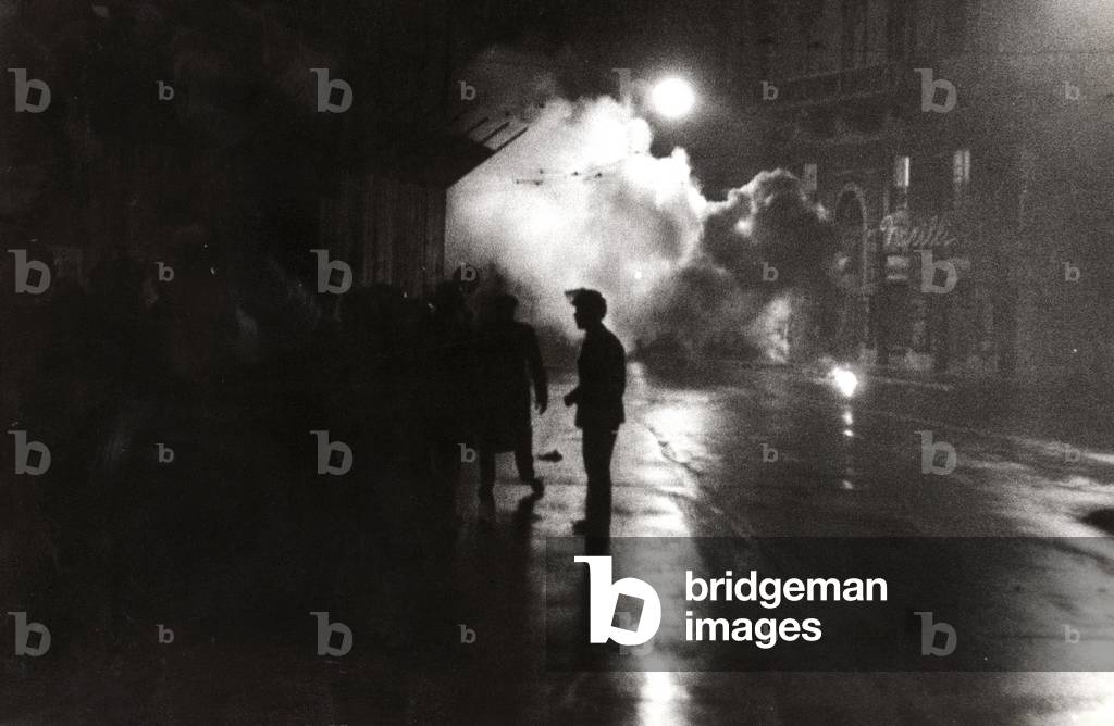 Police officers running to a fire in the street