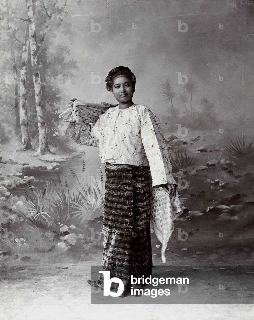 A young Thai woman, in traditional costume, photographed in front of a stream of water, 1900 (print on double-weight paper)
