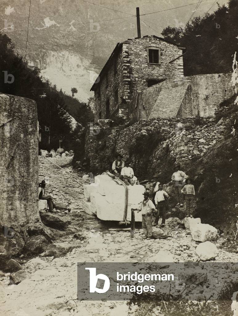 Portrait of a group of marble quarrymen transporting blocks of stone (b/w photo)