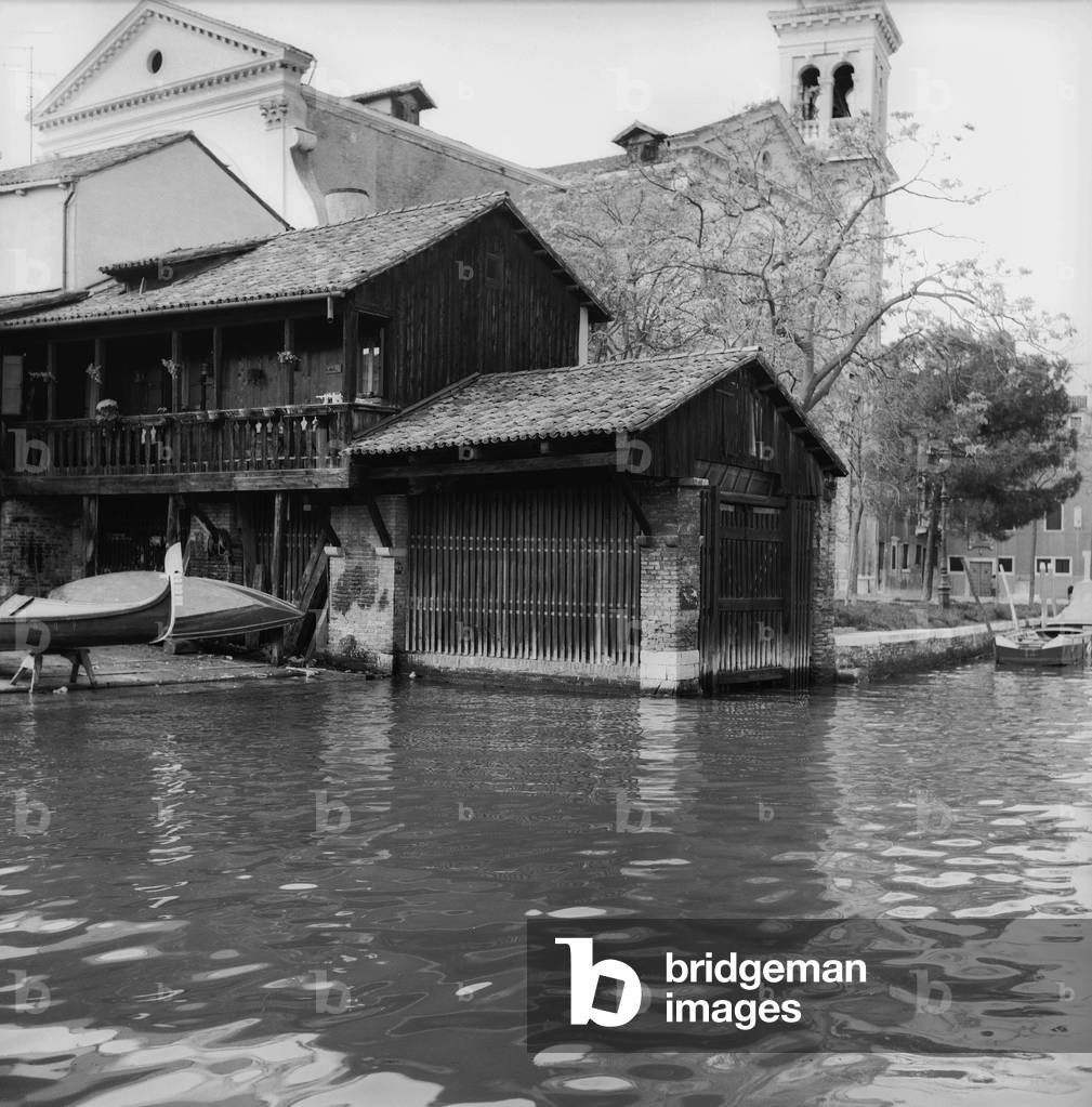 Remittance of Gondolas in a canal in Venice (b/w photo)