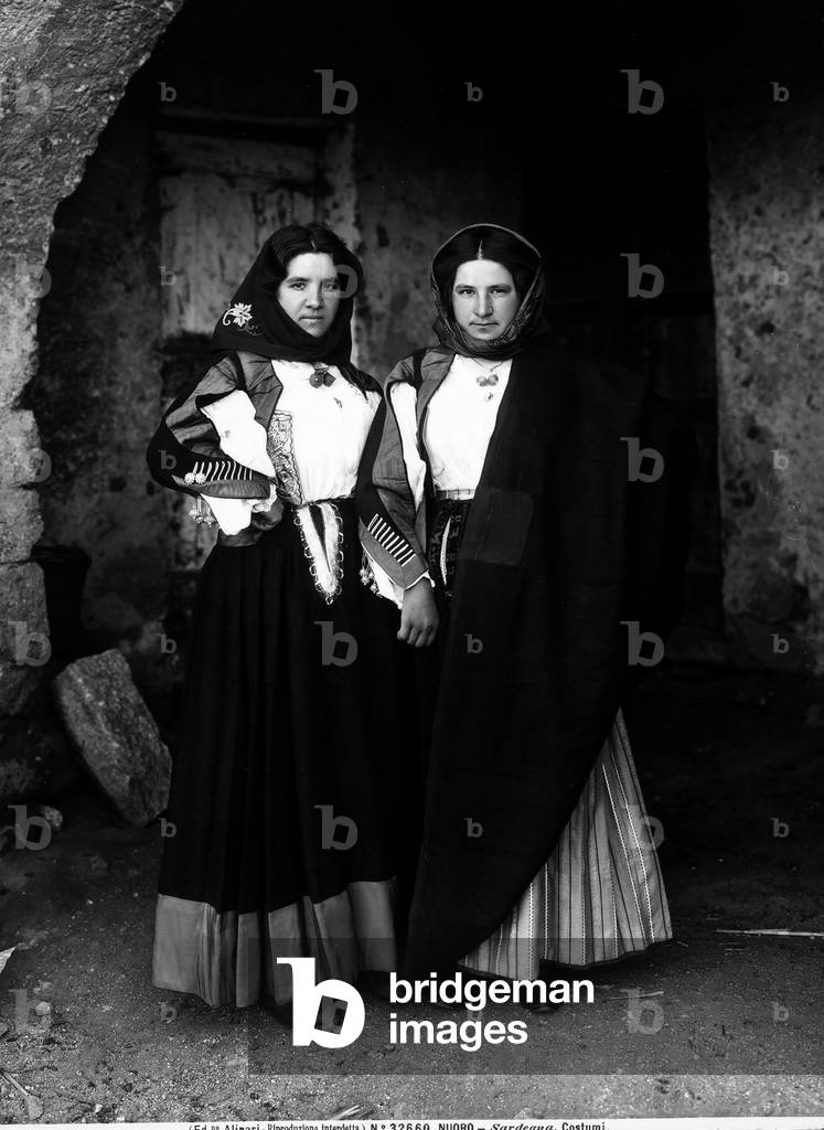 Full figure shot of two young woman in popular Sardinian dress.