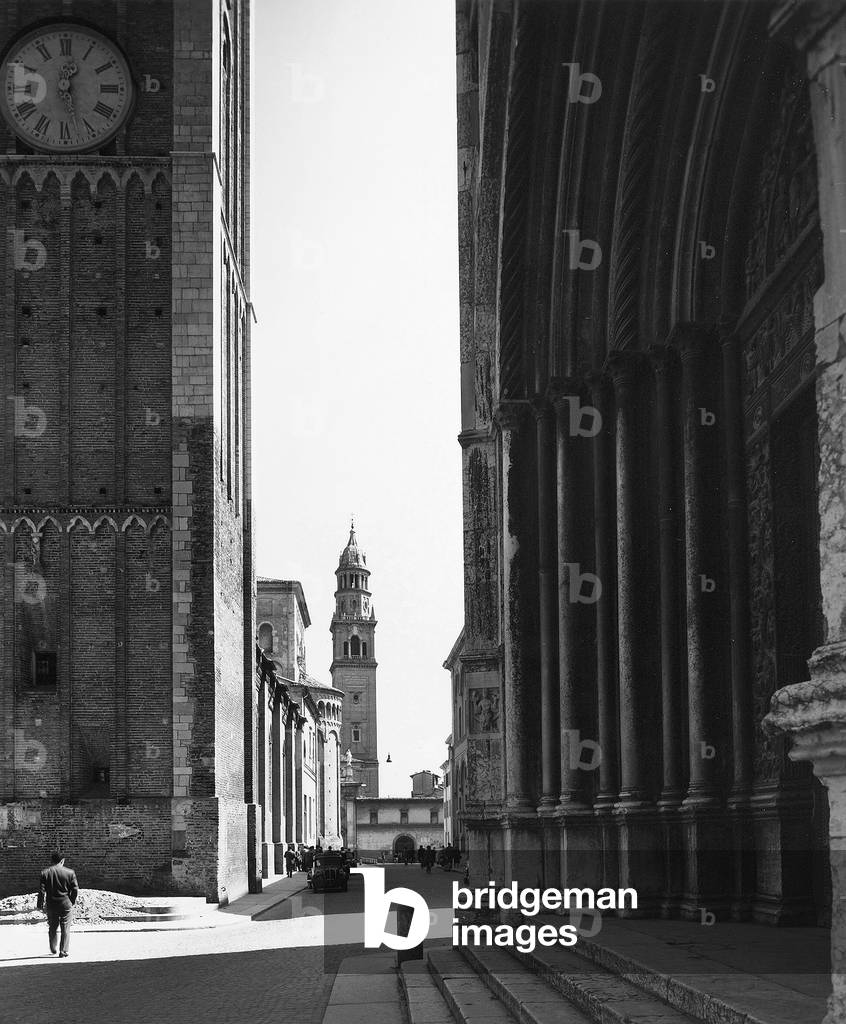Doorway of the Baptistry and detail of the bell tower of the Cathedral, in Parma