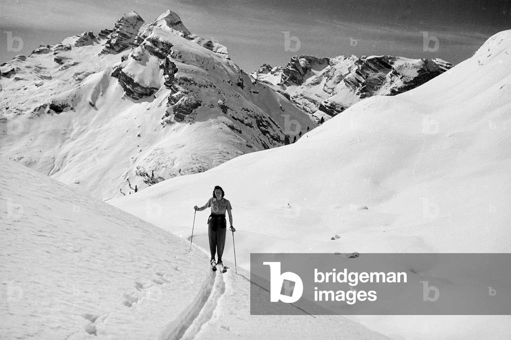 Woman on the skis in a snowy mountain landscape, Cortina d'Ampezzo