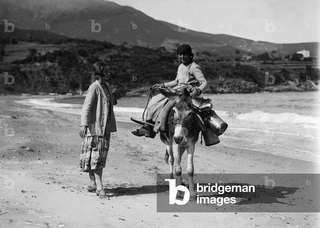 Portrait of a young man sitting on a donkey in the island's beach Procchio, Marciana, Elba Island