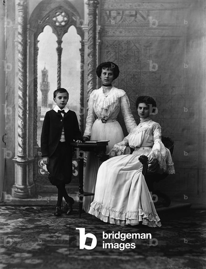 Portrait in studio of two young women with a child