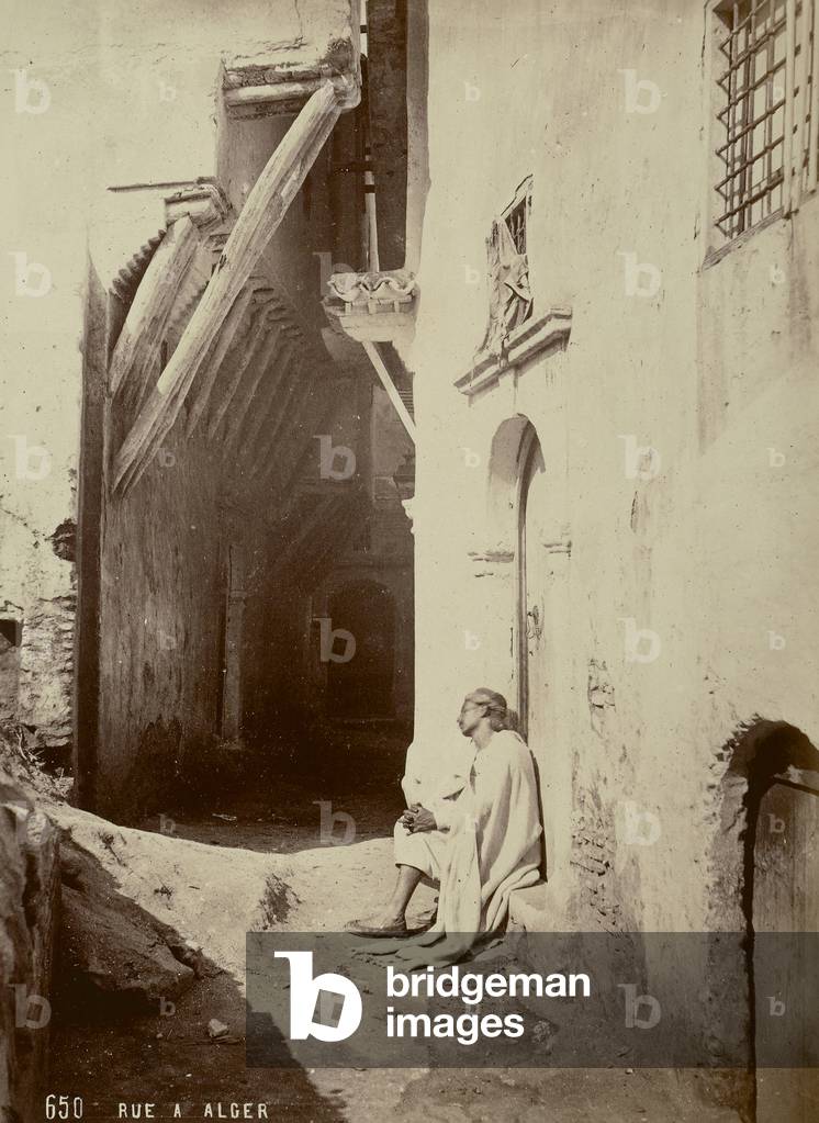 A man asleep in a doorway of an alley, in Algiers, 1880 (print on double-weight paper)