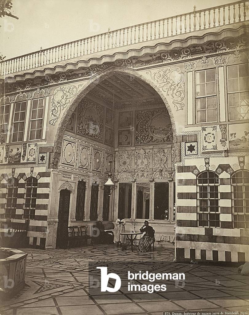 Interior of a Jewish house in Stambouli, Syria. Two women are shown under a portico