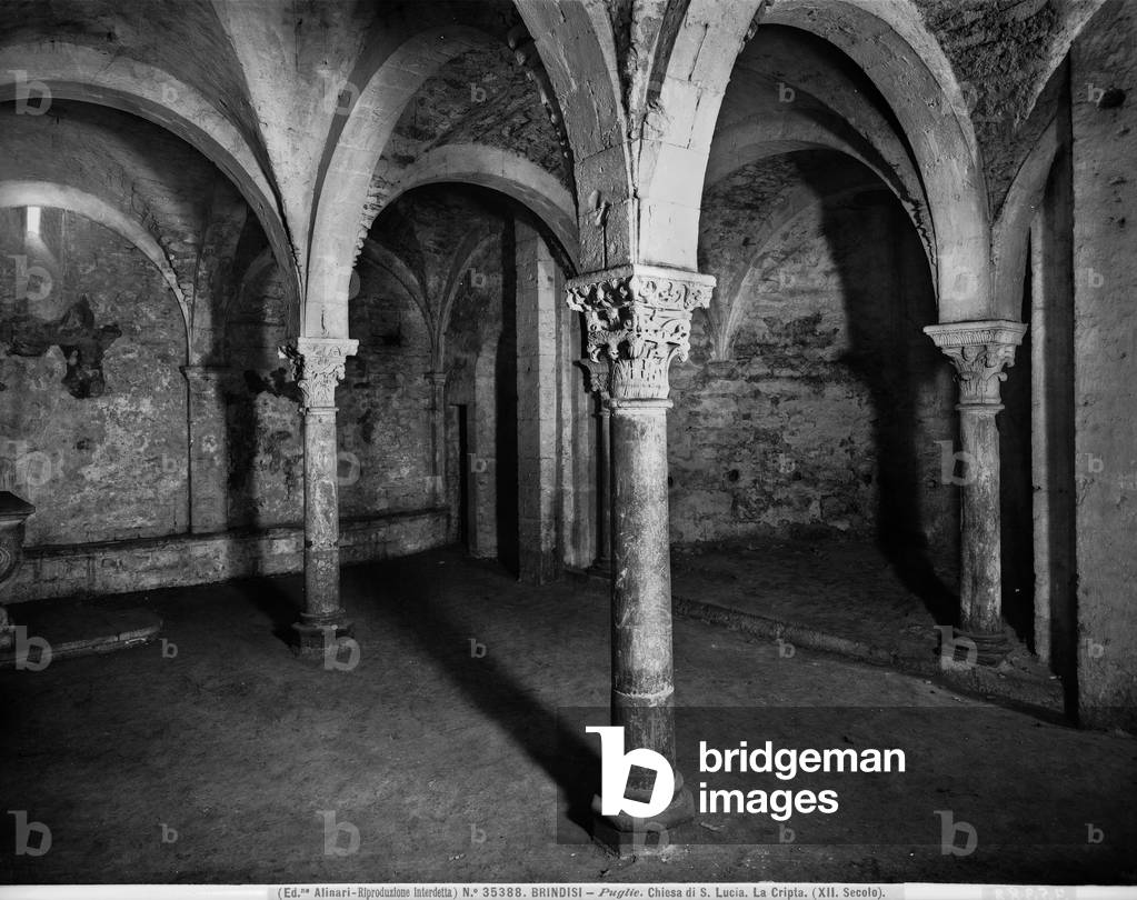Partial view of the Crypt of the church of S. Lucia or SS. Trinità in Brindisi. Some visible columns with capitals are decorated with figures.