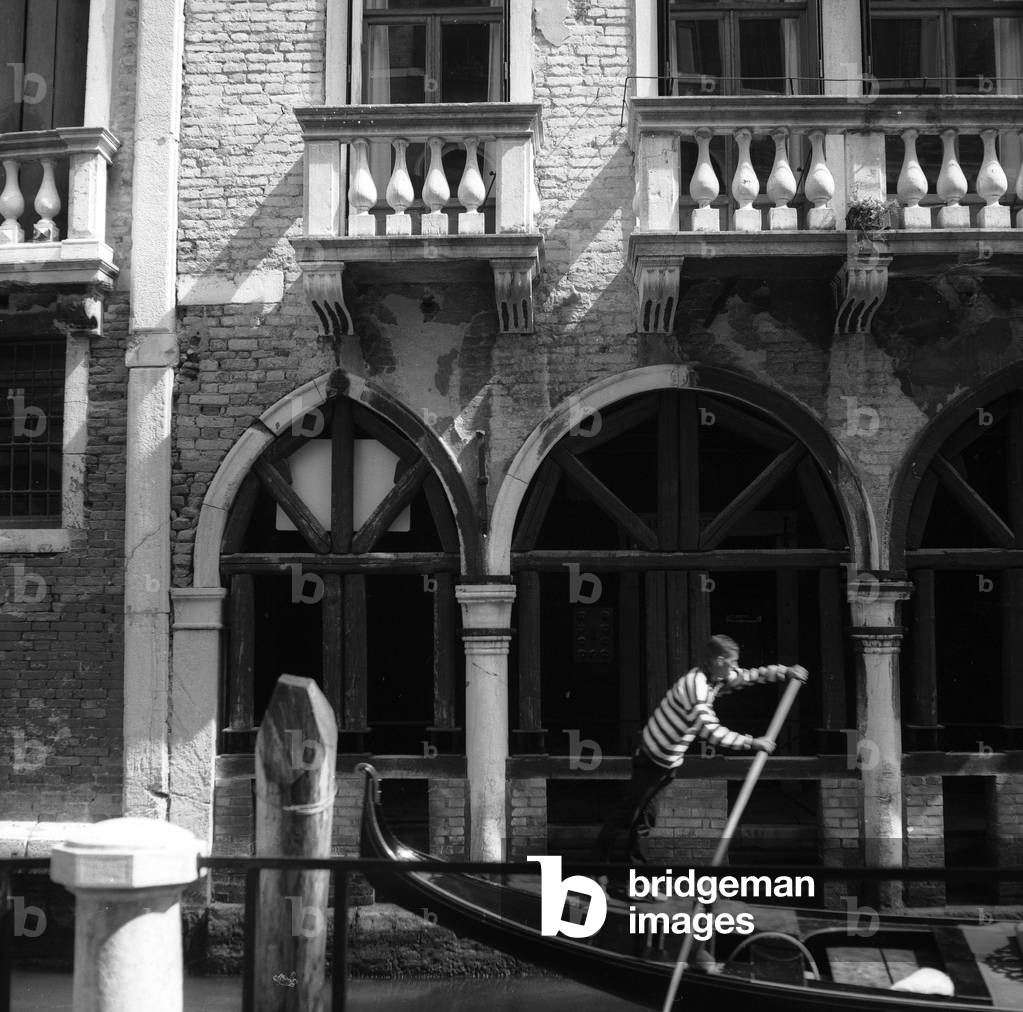 Passing of a gondola in a Venetian canal (b/w photo)
