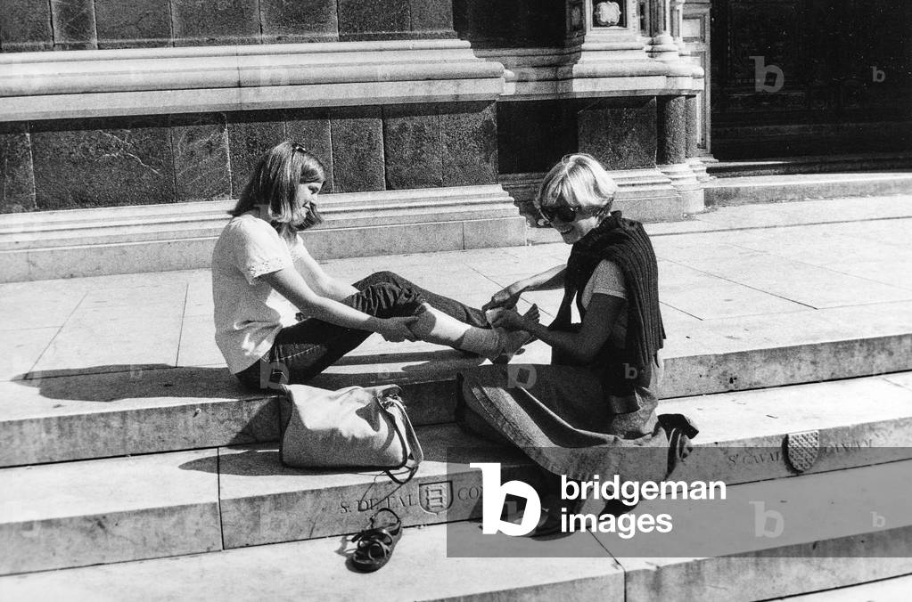 Tourists on the steps of a church in Tuscany