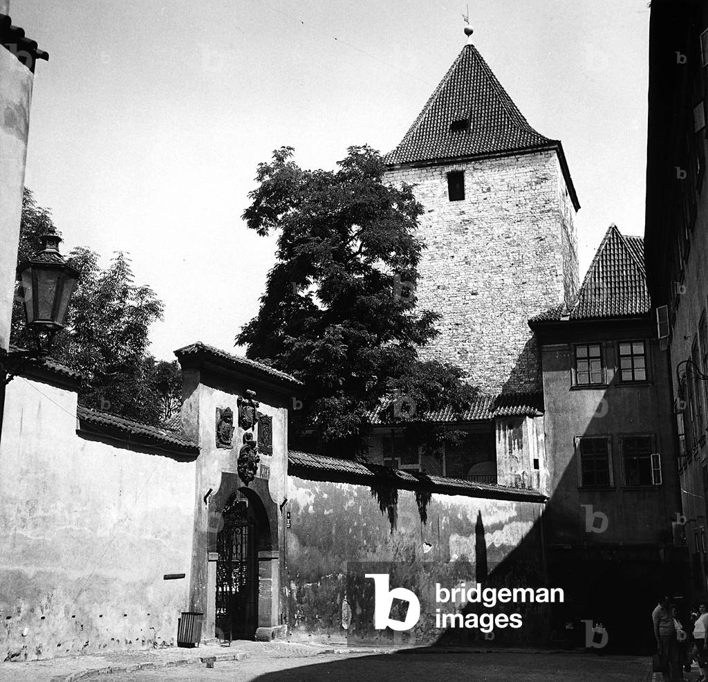 The Zlatá ulicka, or golden alley, in Prague. A fortified tower is seen in the background