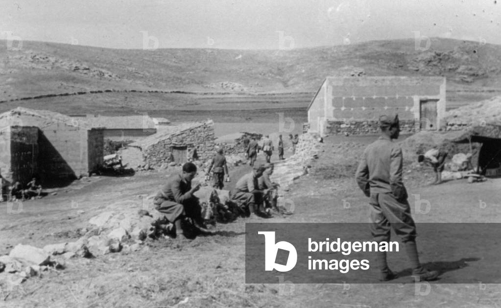 Italian soldiers of the Third Company photographed resting during their temporary lodgings in farm buildings in the course of the Spanish civil war, 07/1938 (b/w photo)