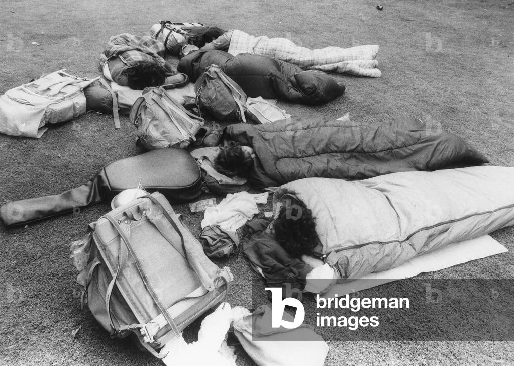 A group of youth sleeping outside in sleeping bags, waiting for a concert of the Rolling Stones, c.1965 (b/w photo)