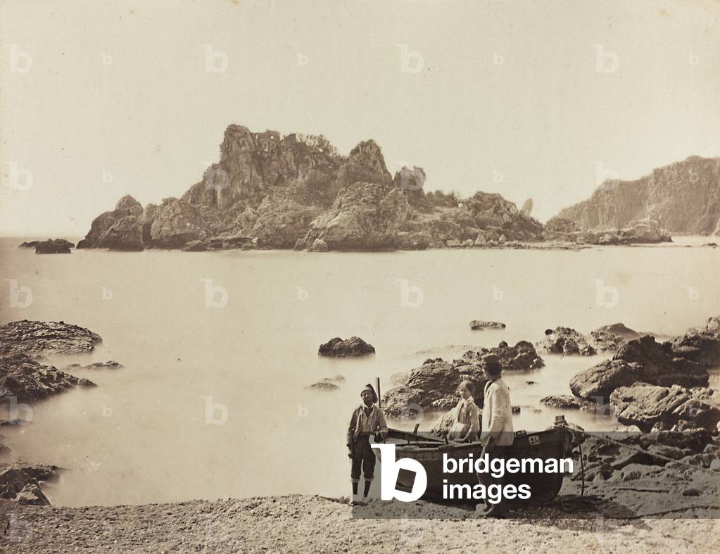 A group of people posing next to a boat on the beach of Taormina