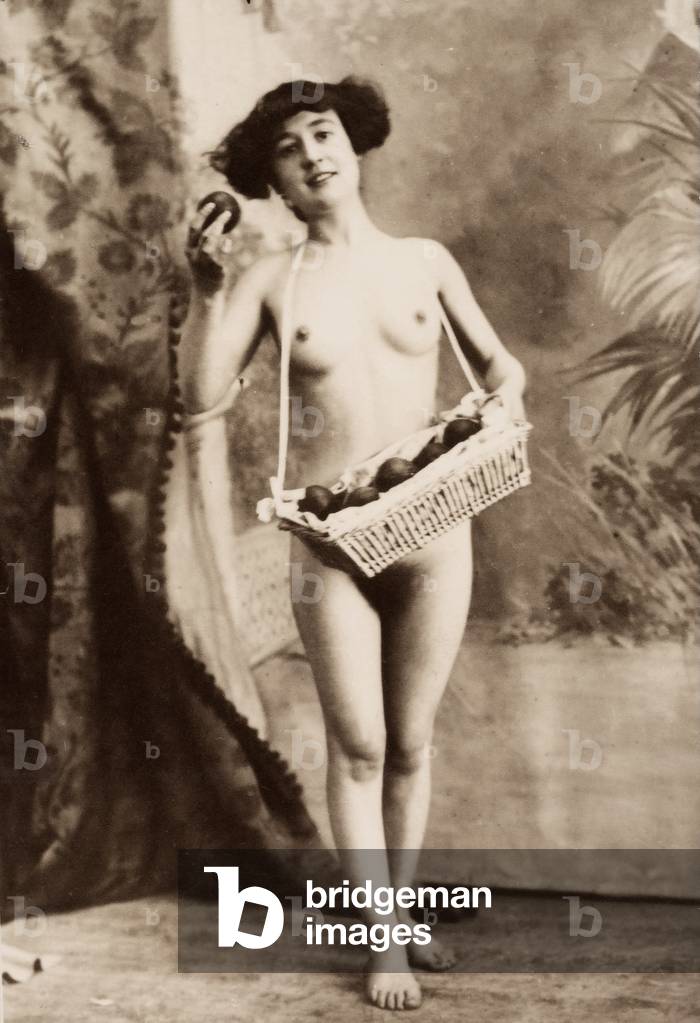 Full-length portrait of a young woman, nude, with a basket full of apples, c.1910 (print)