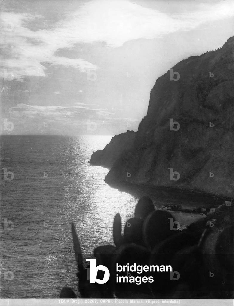 A steep promontory that juts into the sea of Capri at sunset.
