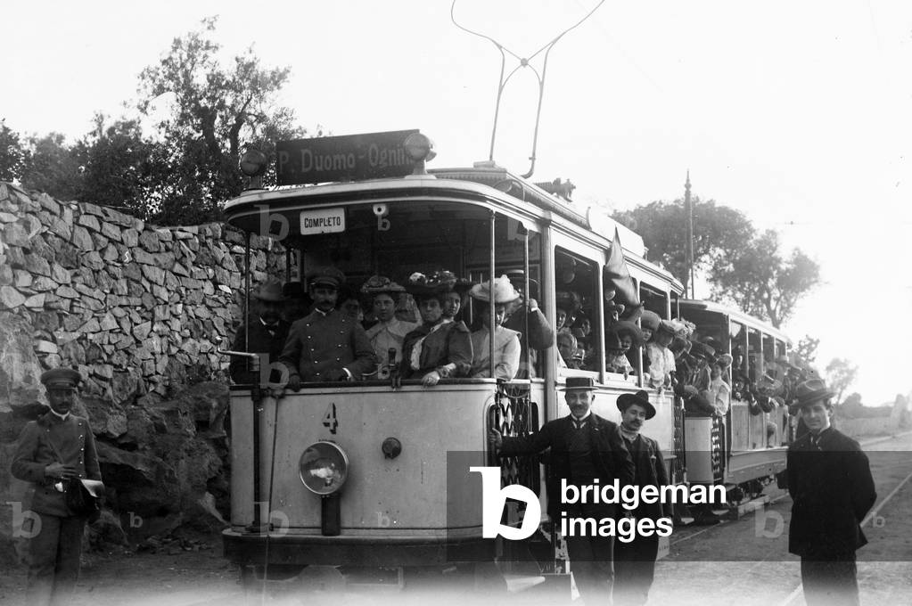 Tram passengers crowded in a street in Catania