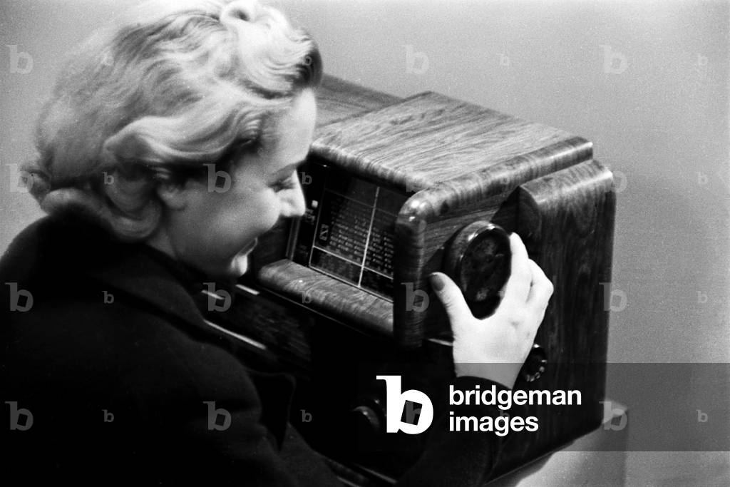 Young woman with a radio made by the Superla company